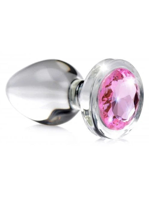 Metallic anal plug with a pink gemstone on a white background