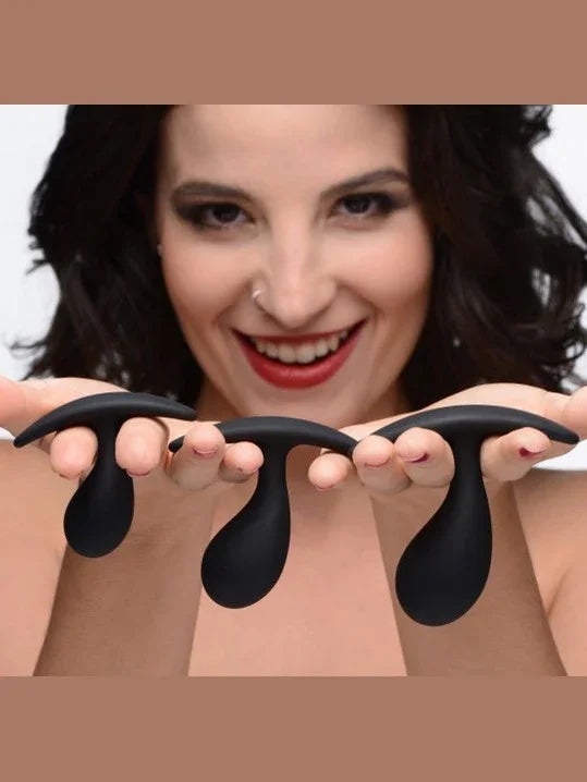 Woman holding two black silicone cups against a neutral background