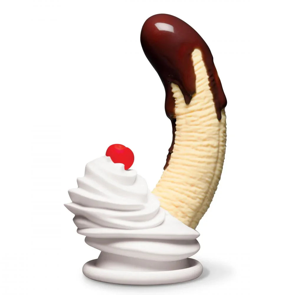 Ice cream sculpture with vanilla wafers, whipped cream, and a cherry on a white background