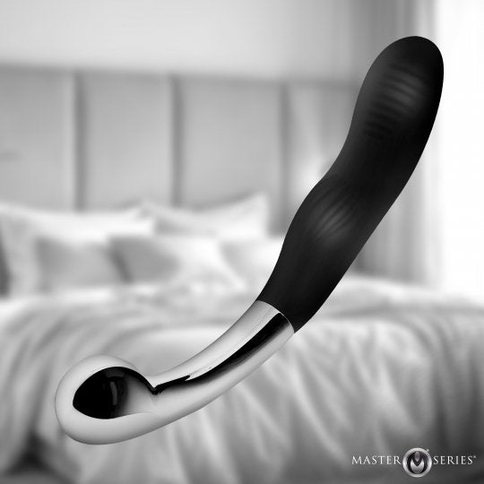 A black and silver curved personal massager floating in front of a softly blurred bedroom background, with the Master Series logo in the bottom right corner.
