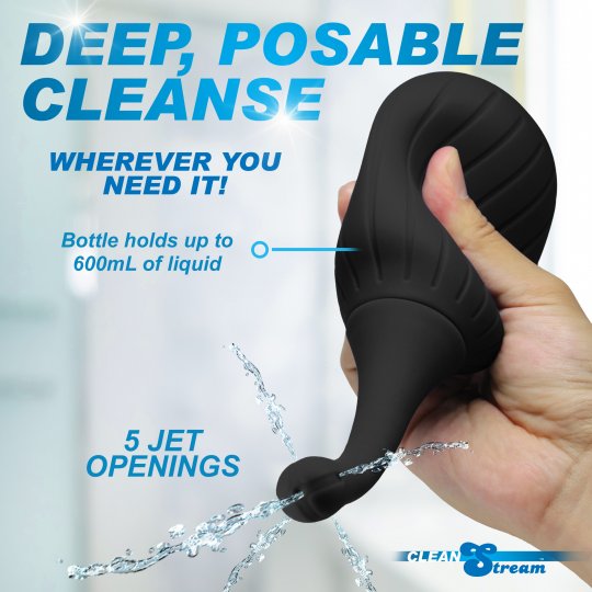 Black handheld cleaning device with water flowing, held by a hand, against a white background.