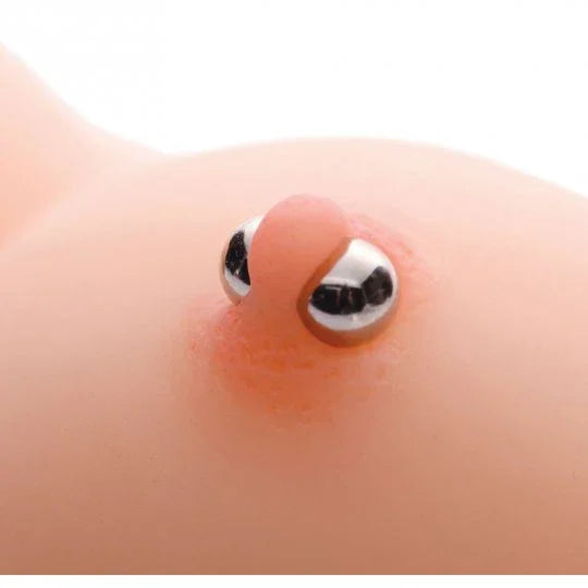 Close-up of a silver belly button ring on a white background