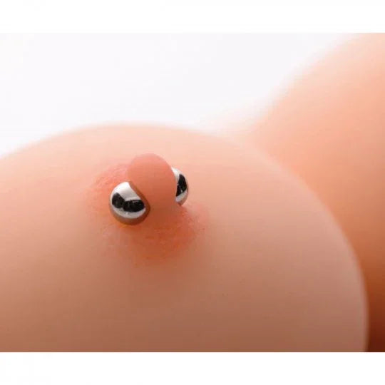 Close-up of a belly button ring on a white background