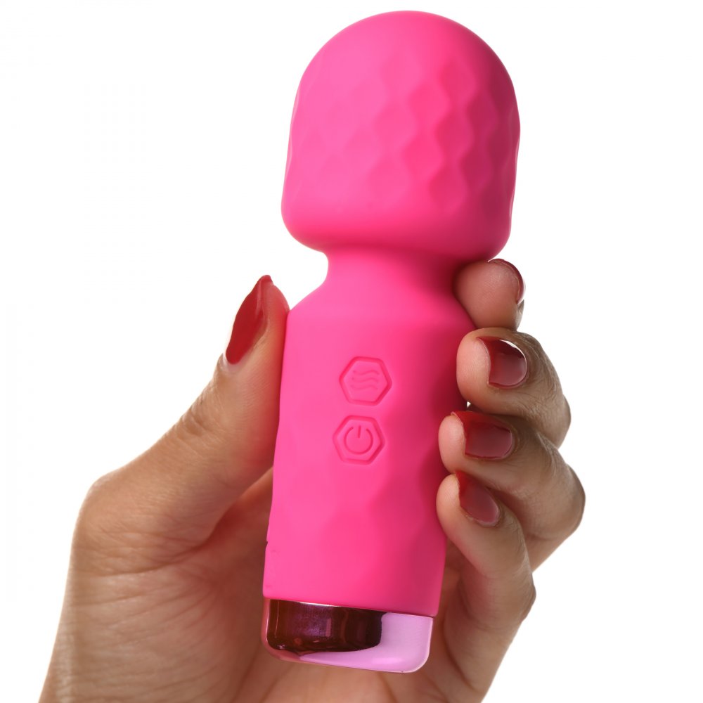 Pink handheld device held by a hand with red nail polish on a white background
