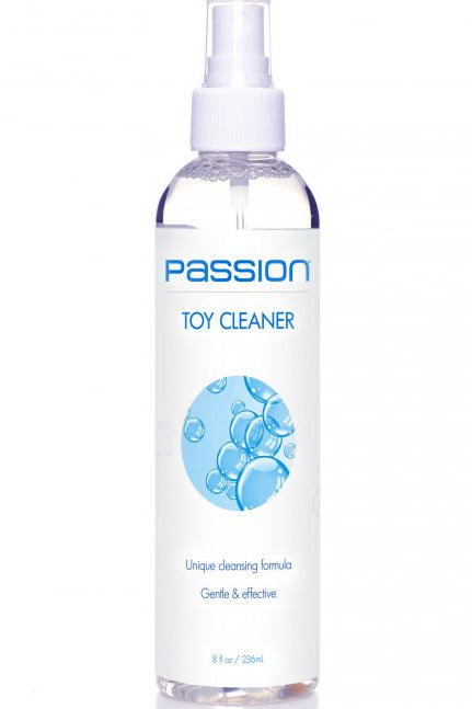 A clear plastic spray bottle of Passion Toy Cleaner with a white spray top and a white label featuring blue text and a blue bubble graphic, set against a plain white background.