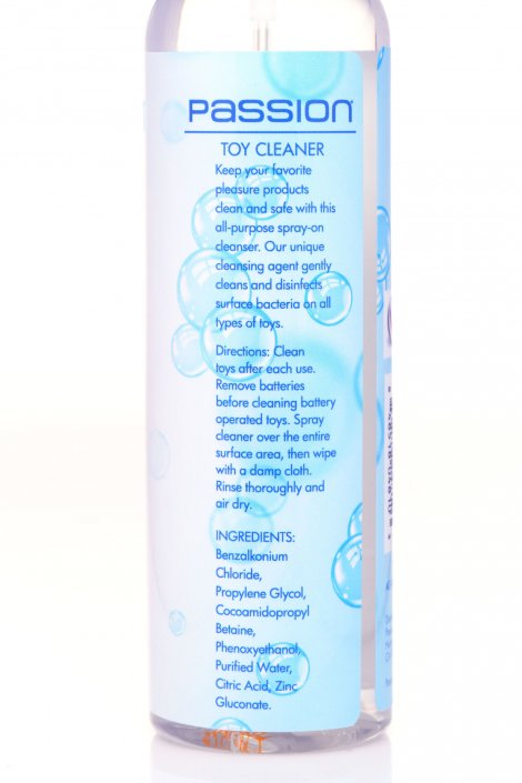 A clear plastic spray bottle of Passion Toy Cleaner with a white spray top and a white label featuring blue text and a blue bubble graphic, set against a plain white background.