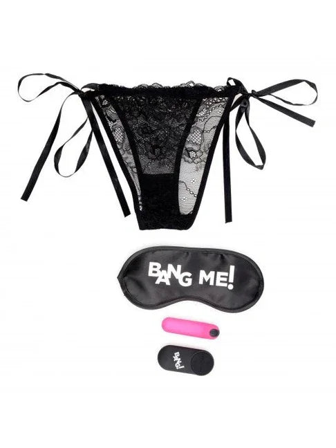 Black lace lingerie set with 'Bang Me!' eye mask and pink earplugs on a white background