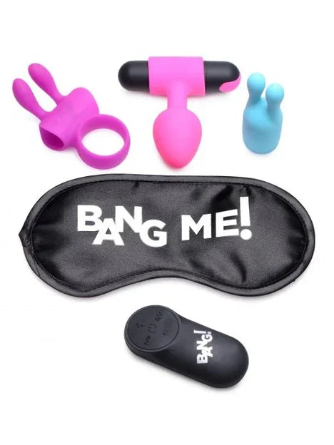 Set of adult toys including a pink rabbit-shaped object, black and pink massager, blue toy, and a black eye mask with 'BANG ME!' text on a white background.