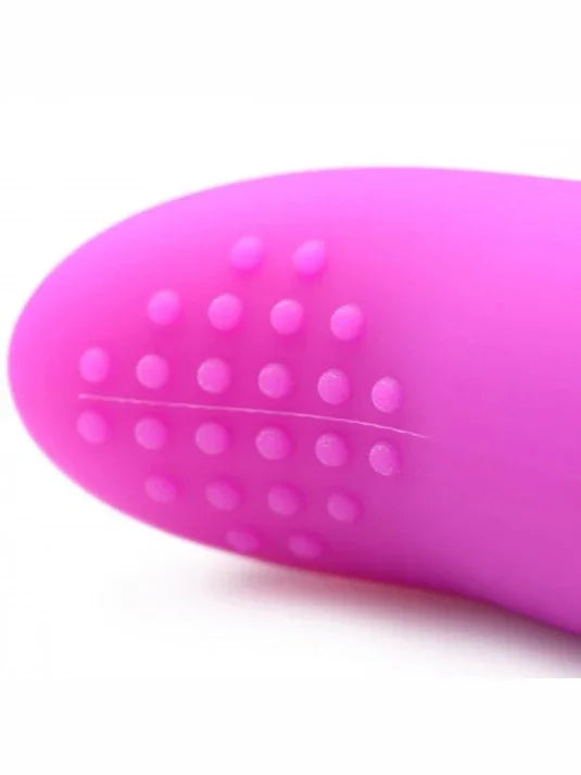 Close-up of a pink silicone tool with textural surface on a white background