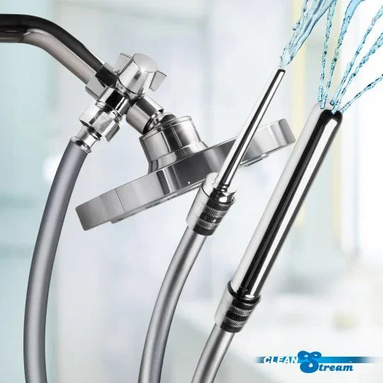 Chrome shower head with flexible hose and water stream on a blurred background