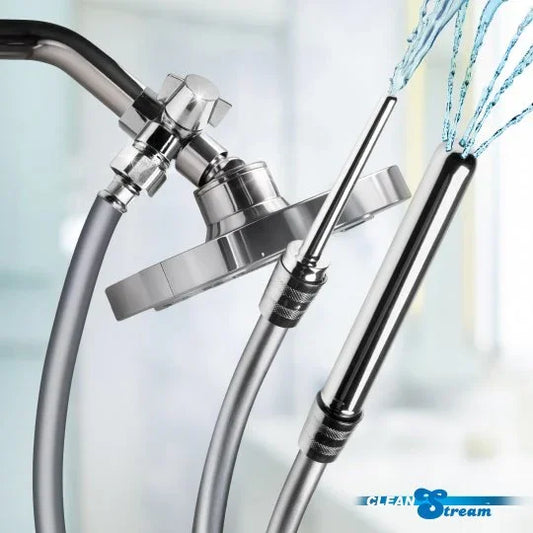 Chrome shower head with flexible hose and water stream on a blurred background