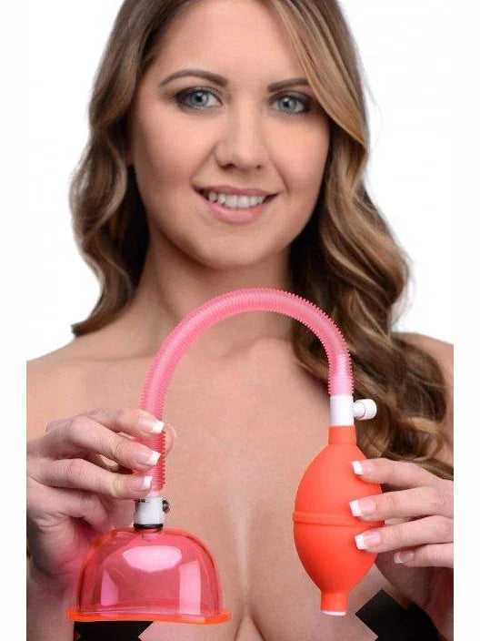 Woman holding a red breast pump with a clear background